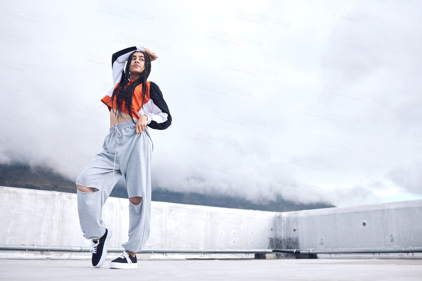 Buy stock photo Woman, hip hop and outdoor fashion in city for freedom with streetwear, style inspiration and unique clothes on concrete. Gen z girl, urban rooftop and creative aesthetic for designer brand with sky