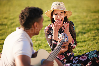 Buy stock photo Music, guitar and couple on picnic in park laughing, singing and romance, happy celebration of valentines day. Nature, love and man and woman on romantic date on the grass on summer weekend together.
