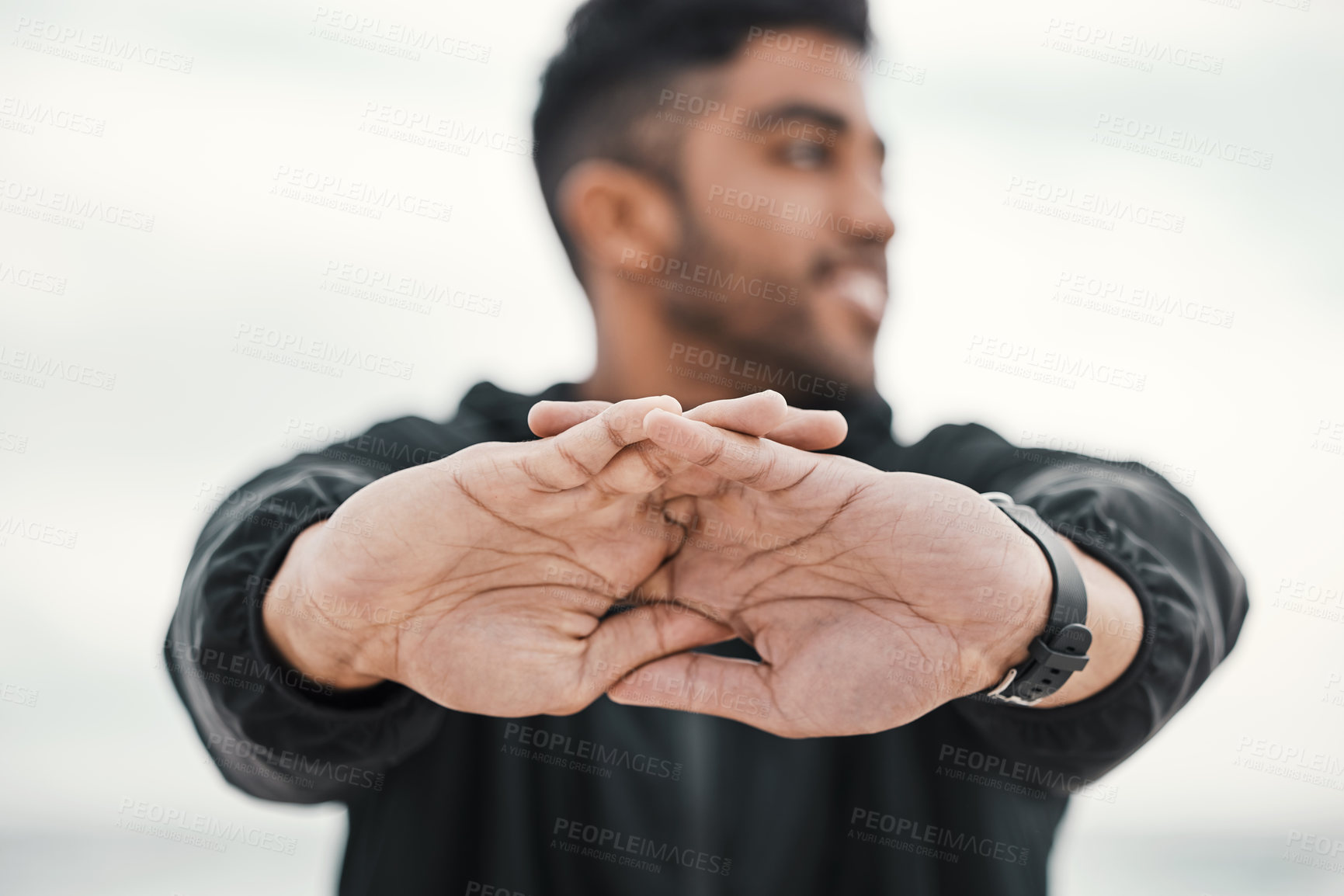 Buy stock photo Man, stretching hands and ready in outdoor for exercise, runner and cardio for training or workout. Male person, cloudy sky and athlete preparation for fitness, performance and sports for competition