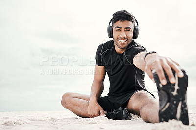 Buy stock photo Beach, headphones or portrait of happy man stretching legs with fitness for body flexibility, music or podcast. Sand, smile or sports athlete in workout, mobility training or exercise warm up at sea