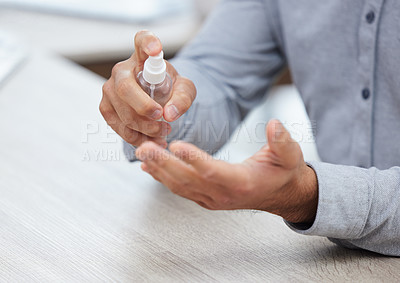 Buy stock photo Shot of a businessman sanitising his hands