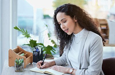 Buy stock photo Shot of a young businesswoman taking notes