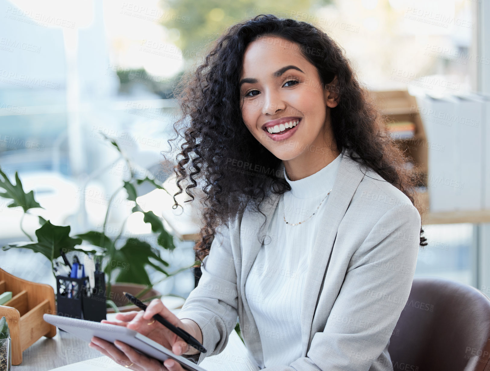 Buy stock photo Shot of a young businesswoman using her digital tablet