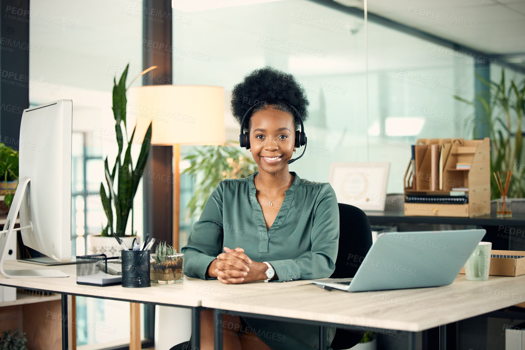 Buy stock photo Portrait of a young businesswoman wearing a headset while working in an office