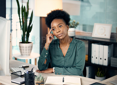 Buy stock photo Shot of a young businesswoman looking thoughtful while working in an office