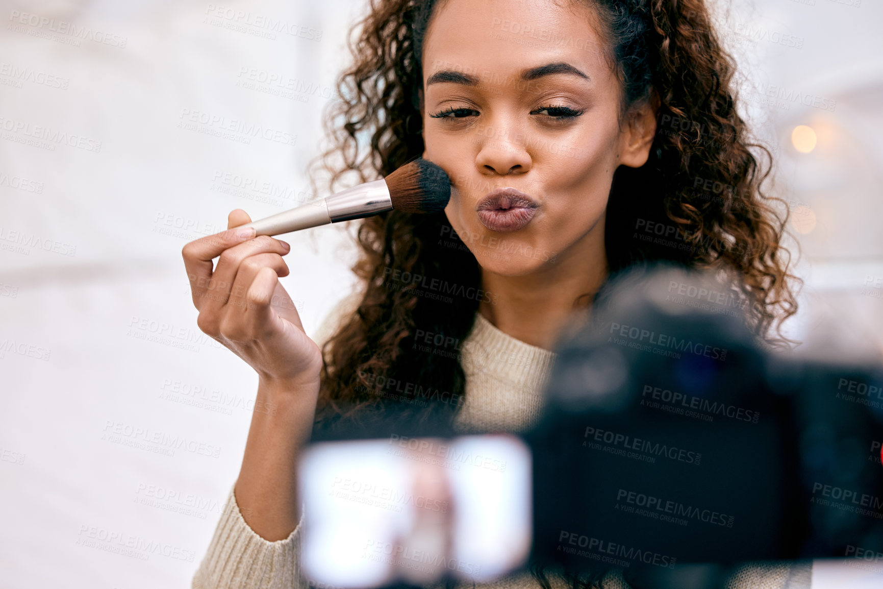 Buy stock photo Shot of a young woman doing her makeup while recording a video for her blog