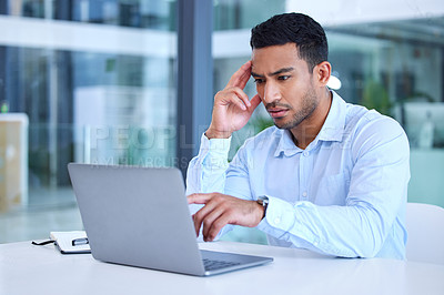 Buy stock photo Shot of a young businessman experiencing a headache at work