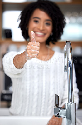 Buy stock photo Shot of a young woman giving the thumbs up with her freshly washed hand