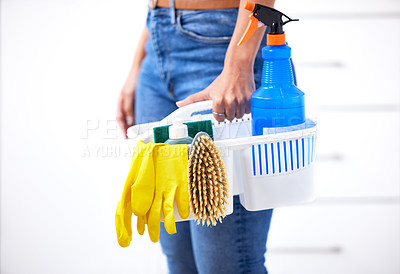 Buy stock photo Shot of a woman holding a basket of cleaning supplies