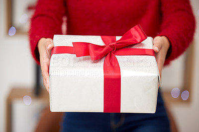 Buy stock photo Shot of an unrecognizable woman opening presents during Christmas at home