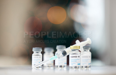 Buy stock photo Covid vaccine, syringe and and table for medical, health and wellness for pandemic safety. Medicine, vial and needle for corona, drug and risk control for disease treatment and pharmaceutical product