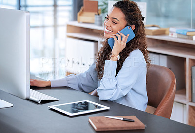 Buy stock photo Cropped shot of an attractive young businesswoman making a phonecall while working on a laptop at her desk in the office