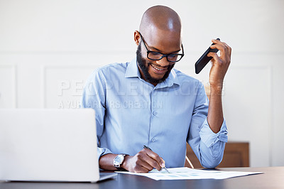 Buy stock photo Shot of a businessman doing paperwork and using his cellphone while sitting at his desk