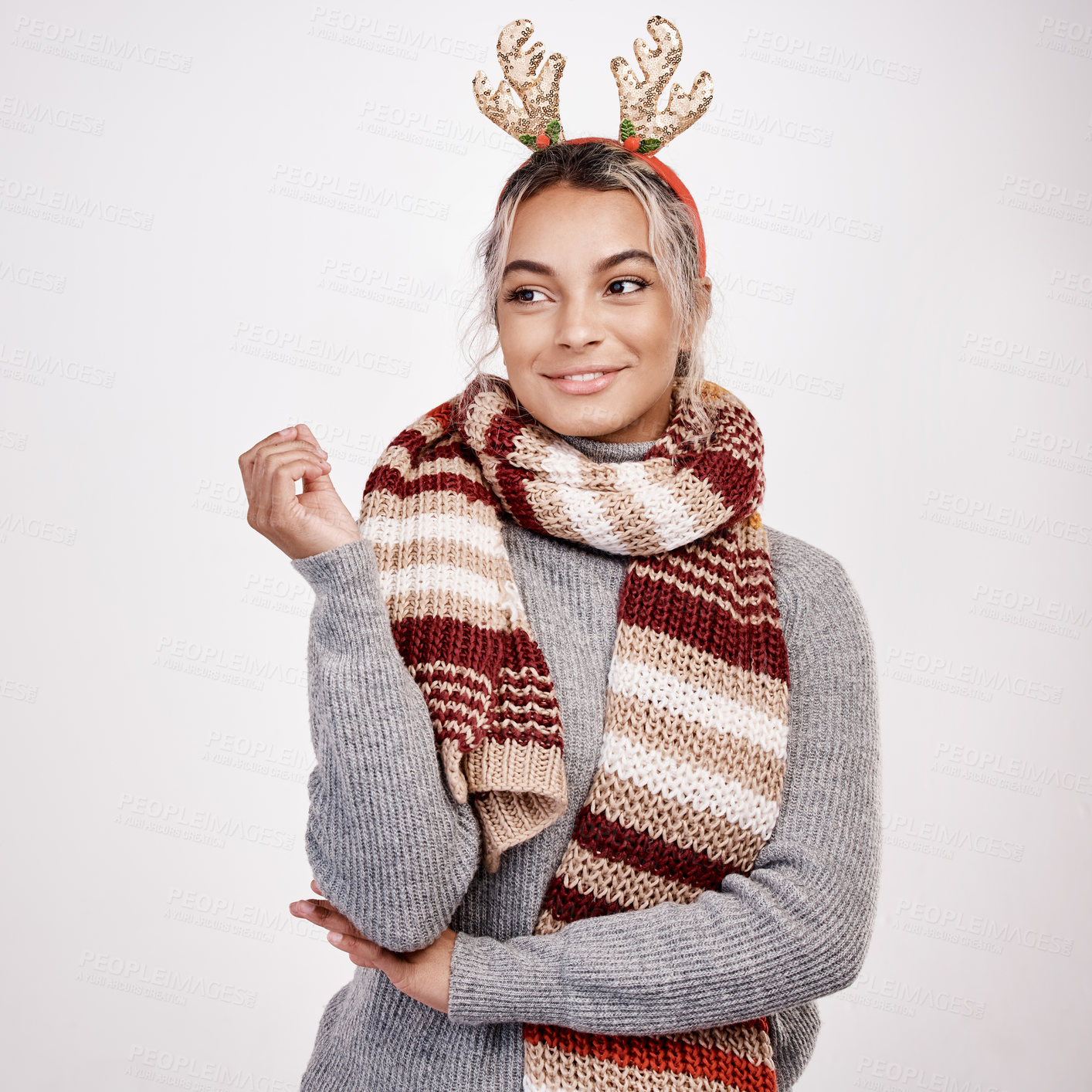 Buy stock photo Studio shot of an attractive young woman looking thoughtful while dressed in Christmas-themed attire
