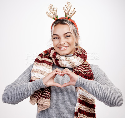 Buy stock photo Portrait, woman and heart with smile at Christmas for festive, winter and holiday on studio backdrop. Female person, cheerful and happy in celebration with shape for love in  season for vacation