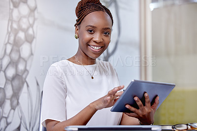 Buy stock photo Portrait of a young woman using a digital tablet in a modern office