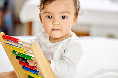 Buy stock photo Abacus, bedroom and baby play with toy for learning, child development and motor skills. Family home, newborn and face of adorable child with educational toys, counting beads and playing in bed
