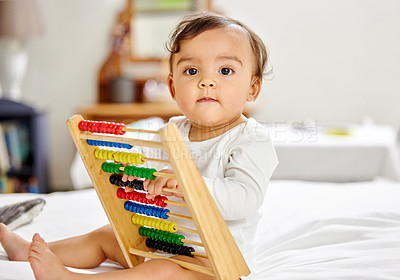 Buy stock photo Abacus, bed and portrait of baby with toy for learning, child development and motor skills. Family home, newborn and face of adorable child with educational toys, counting beads and fun in bedroom