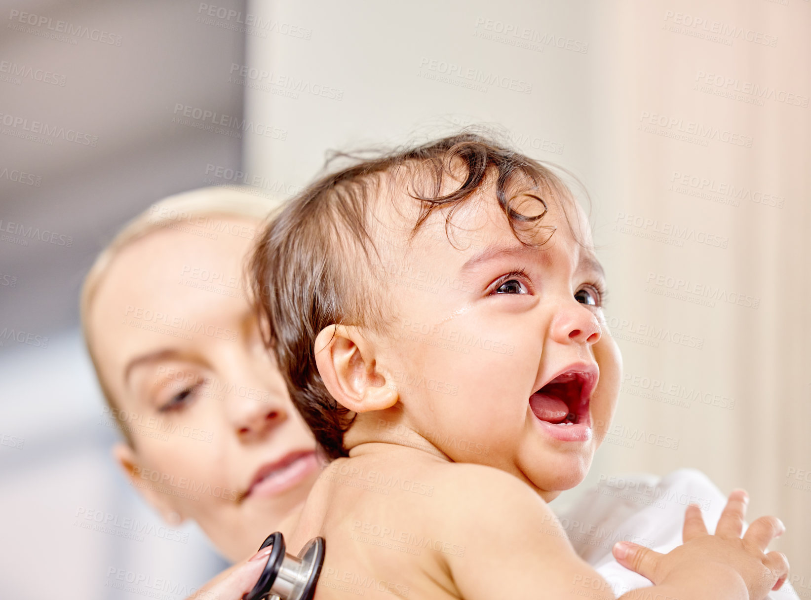 Buy stock photo Sick baby, crying and medical woman with stethoscope for check up, healthcare and illness in family clinic. Child, female physician and hospital bed for upset kid, pediatrician and unwell infant