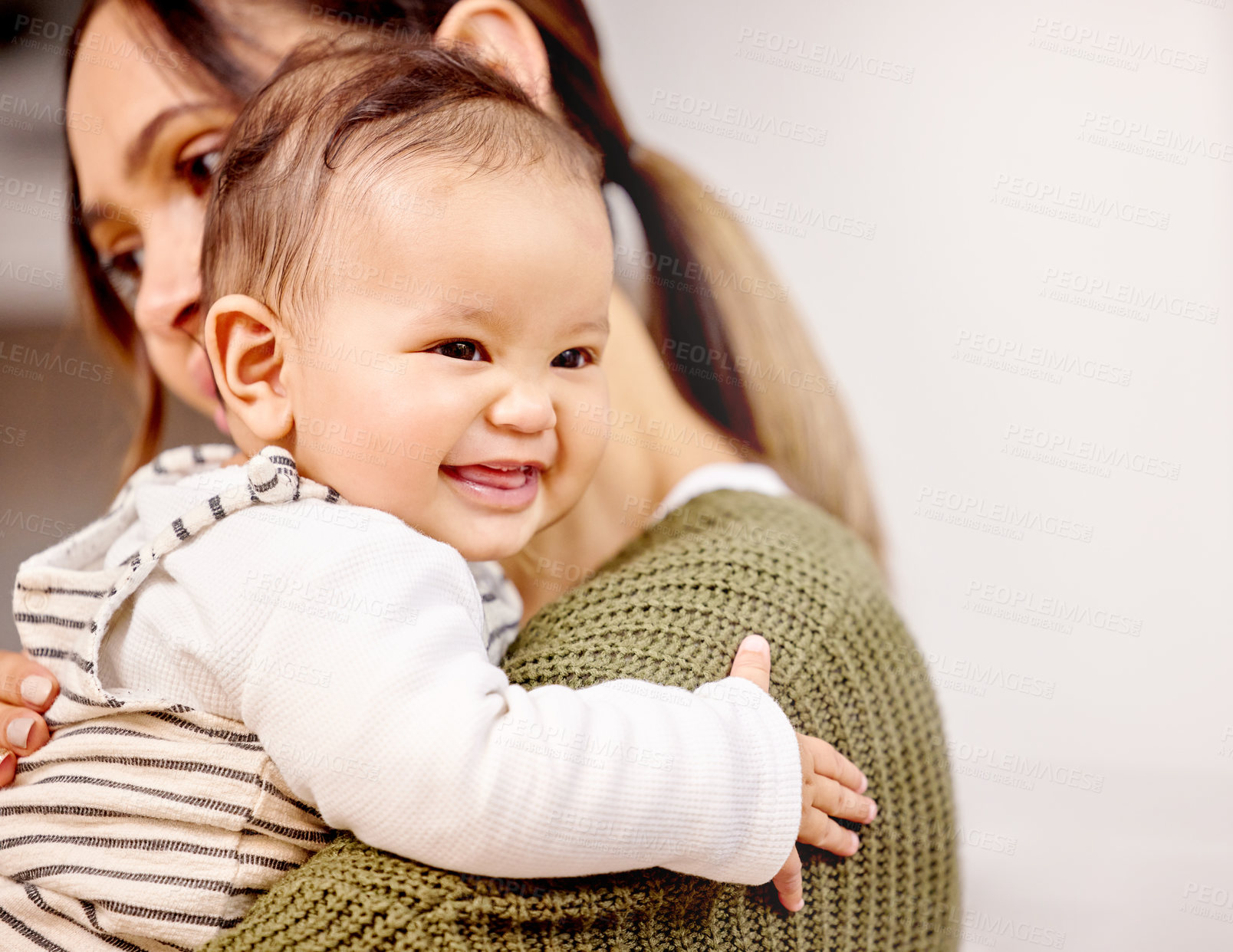 Buy stock photo Shot of a young mother holding her baby