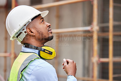 Buy stock photo Shot of a young man working on a construction site outside