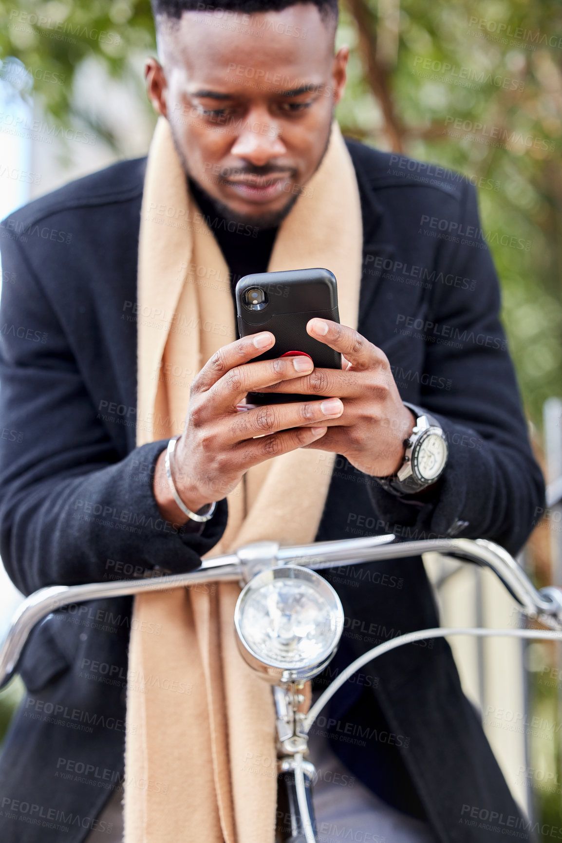 Buy stock photo Shot of a young business man using his cellphone outside