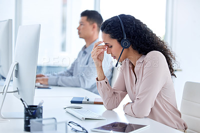 Buy stock photo Shot of a young call centre agent sitting with her colleague and feeling stressed while using her computer