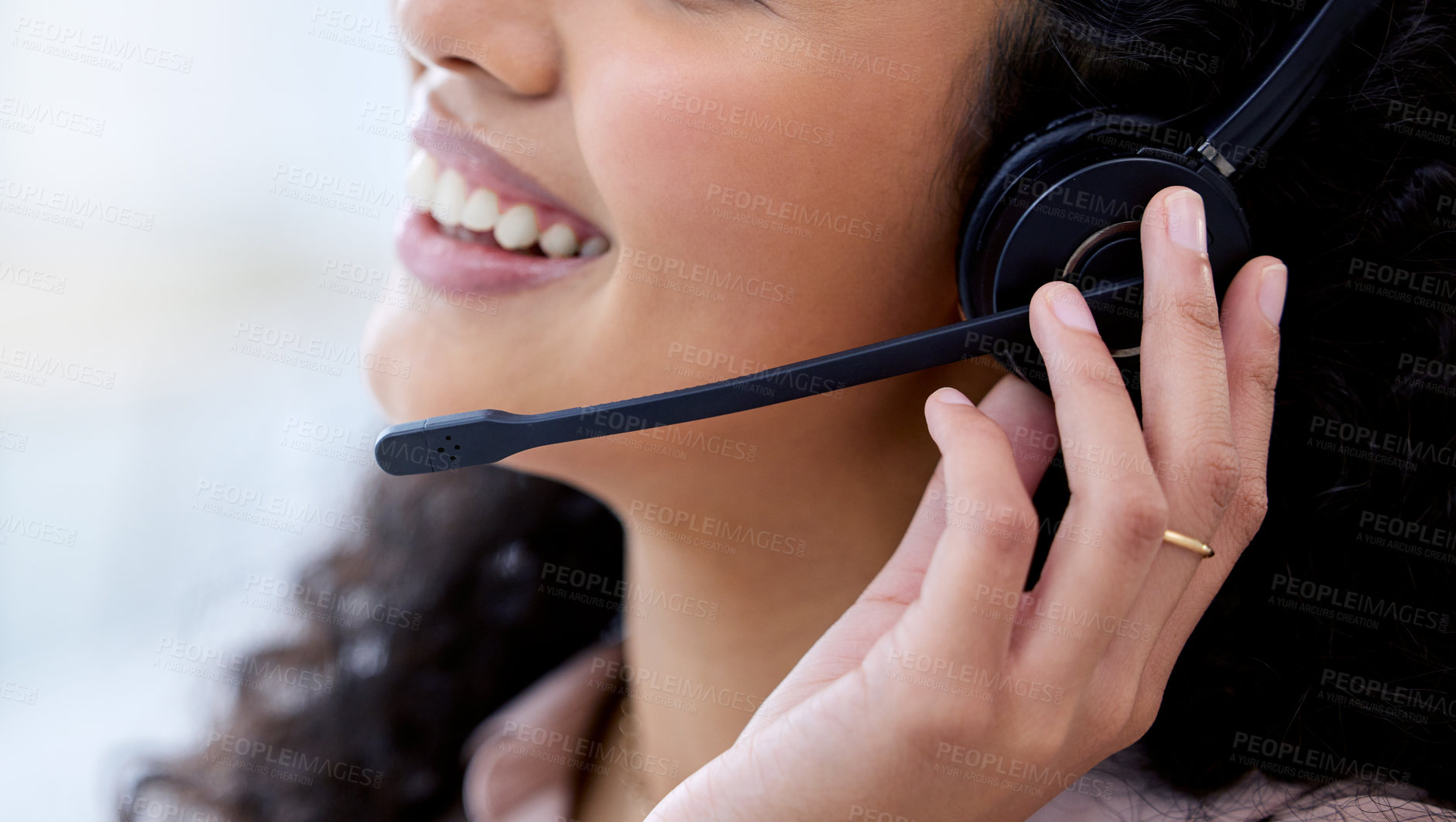 Buy stock photo Cropped shot of an unrecognizable call centre agent sitting alone in her office during the day