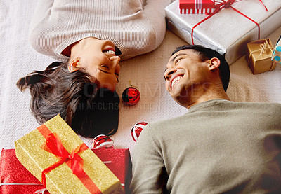 Buy stock photo Gift, couple and happiness on floor for Christmas, smile and giving with love for holiday in apartment. Man, woman and relax in home for celebration, vacation and laugh together for anniversary date