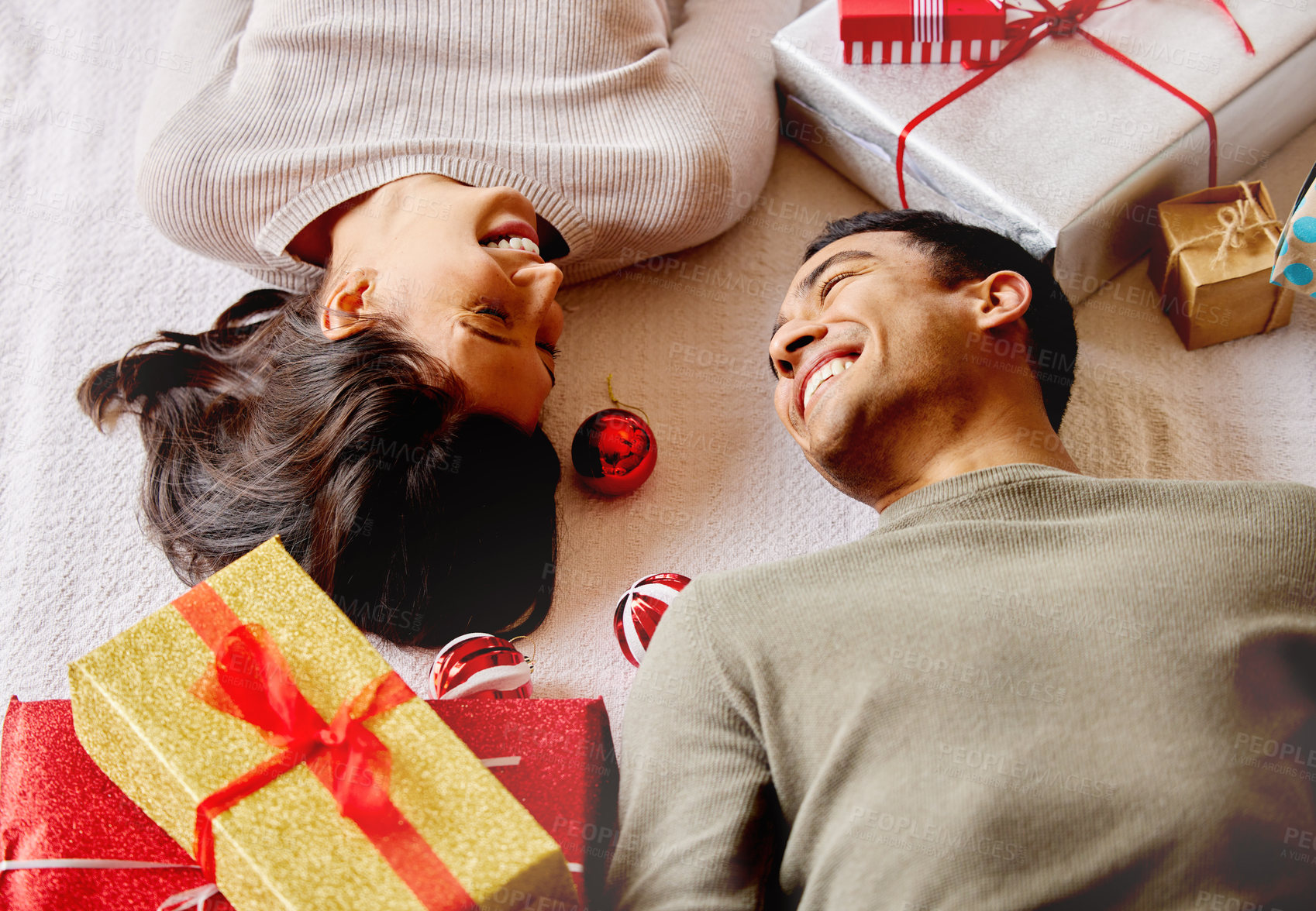 Buy stock photo Gift, couple and happiness on floor for Christmas, smile and giving with love for holiday in apartment. Man, woman and relax in home for celebration, vacation and laugh together for anniversary date