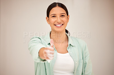 Buy stock photo Shot of a young woman showing a thumbs up against a white background