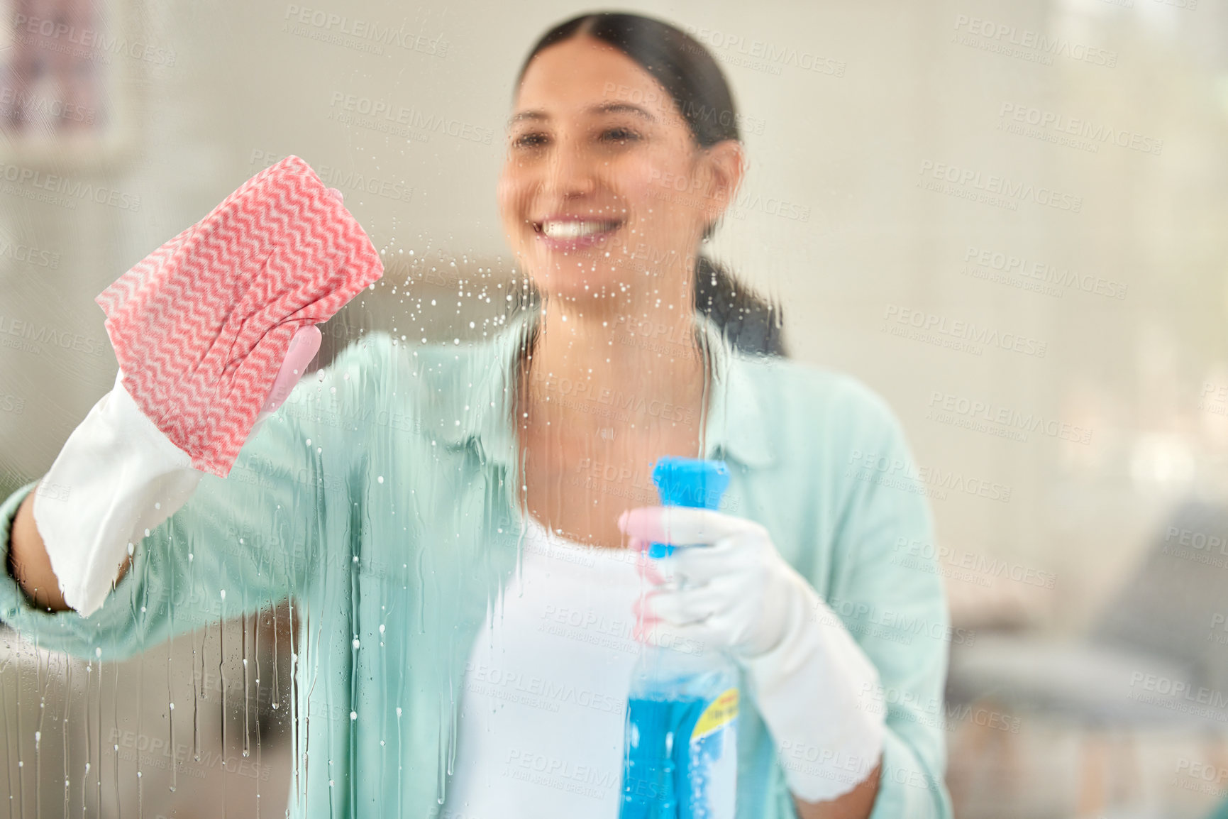 Buy stock photo Woman, window and happy with cloth or spray for hygiene at home on sanitary, satisfied and cleaning. Female person, gloves and smile for house work or housekeeping with care, wellbeing and wash