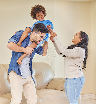 Buy stock photo Shot of a young family playing together in their living room