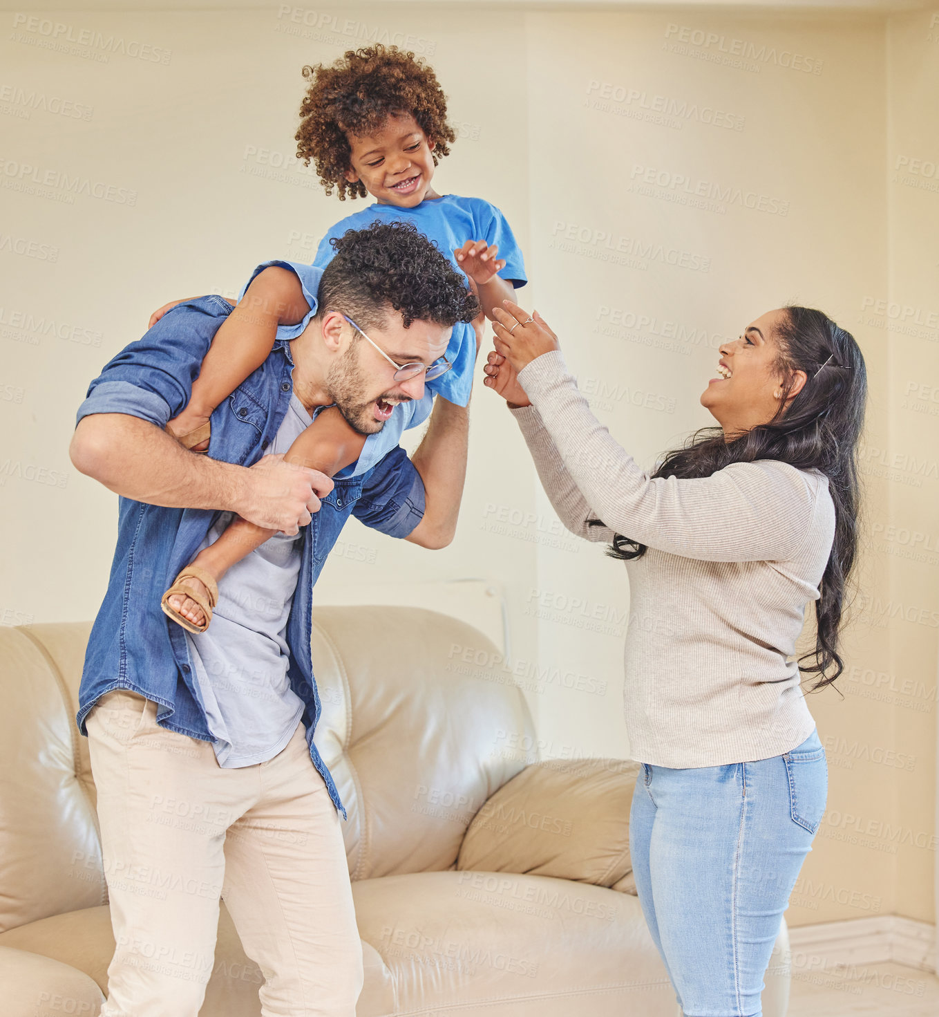 Buy stock photo Shot of a young family playing together in their living room