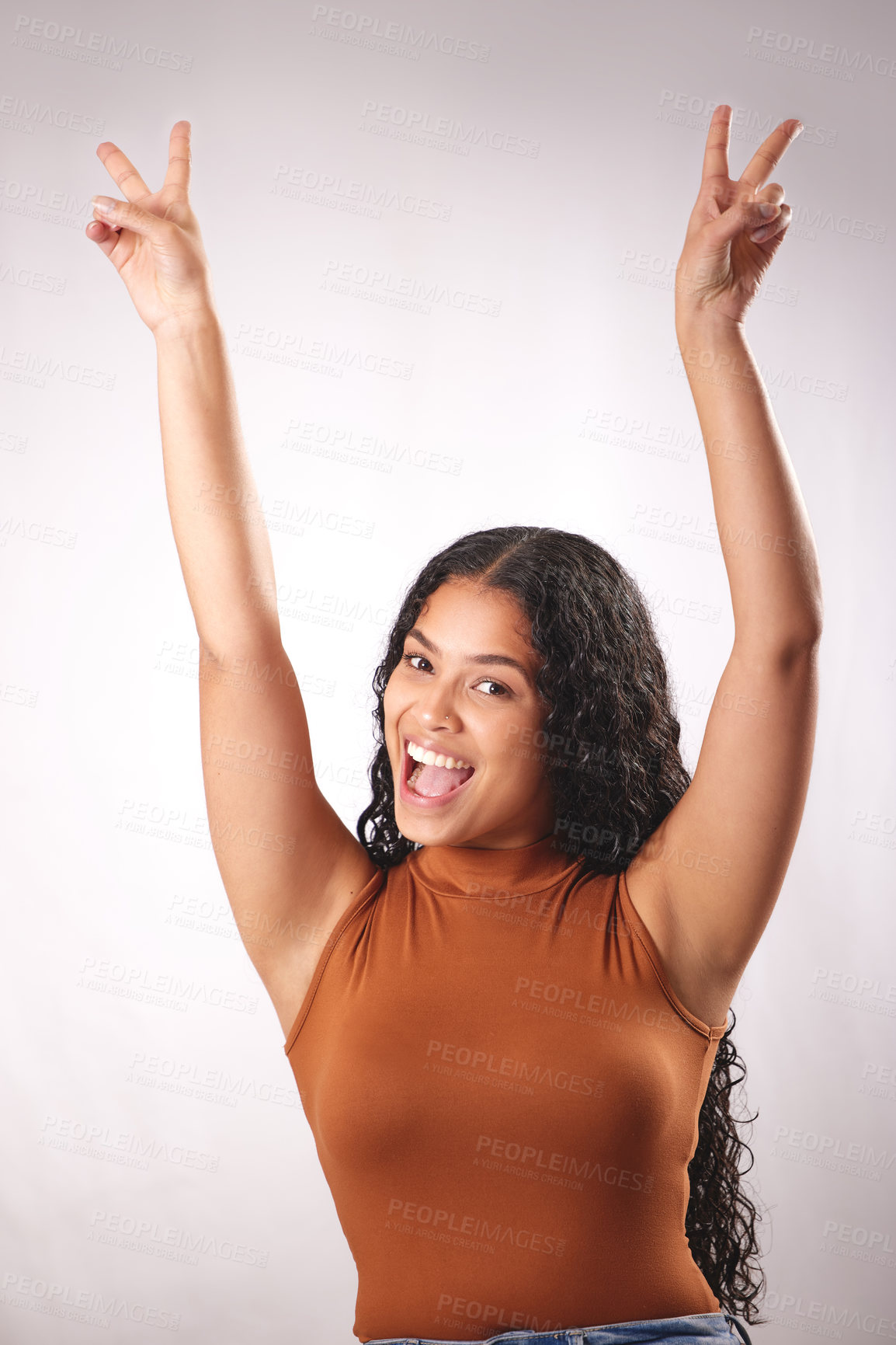 Buy stock photo Studio shot of a beautiful young woman showing the peace sign