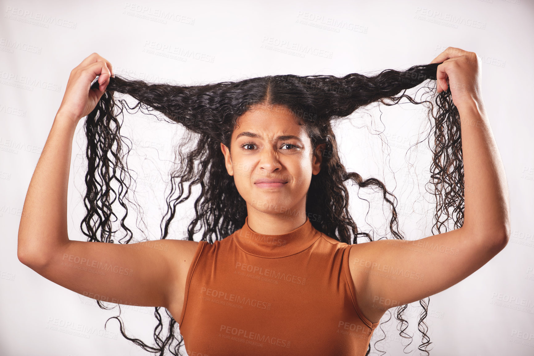 Buy stock photo Shot of a young woman with long brown hair posing in the studio