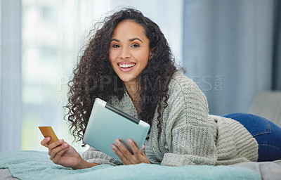 Buy stock photo Shot of a young woman using her digital tablet to make online card payments