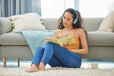 Buy stock photo Relax, reading and woman with books and headphones for learning, knowledge and streaming audiobook. Weekend, home and person with novel, story and literature for hobby, rest or fiction in living room