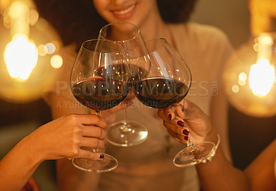 Buy stock photo Shot of a group of female friends clinking wine glasses