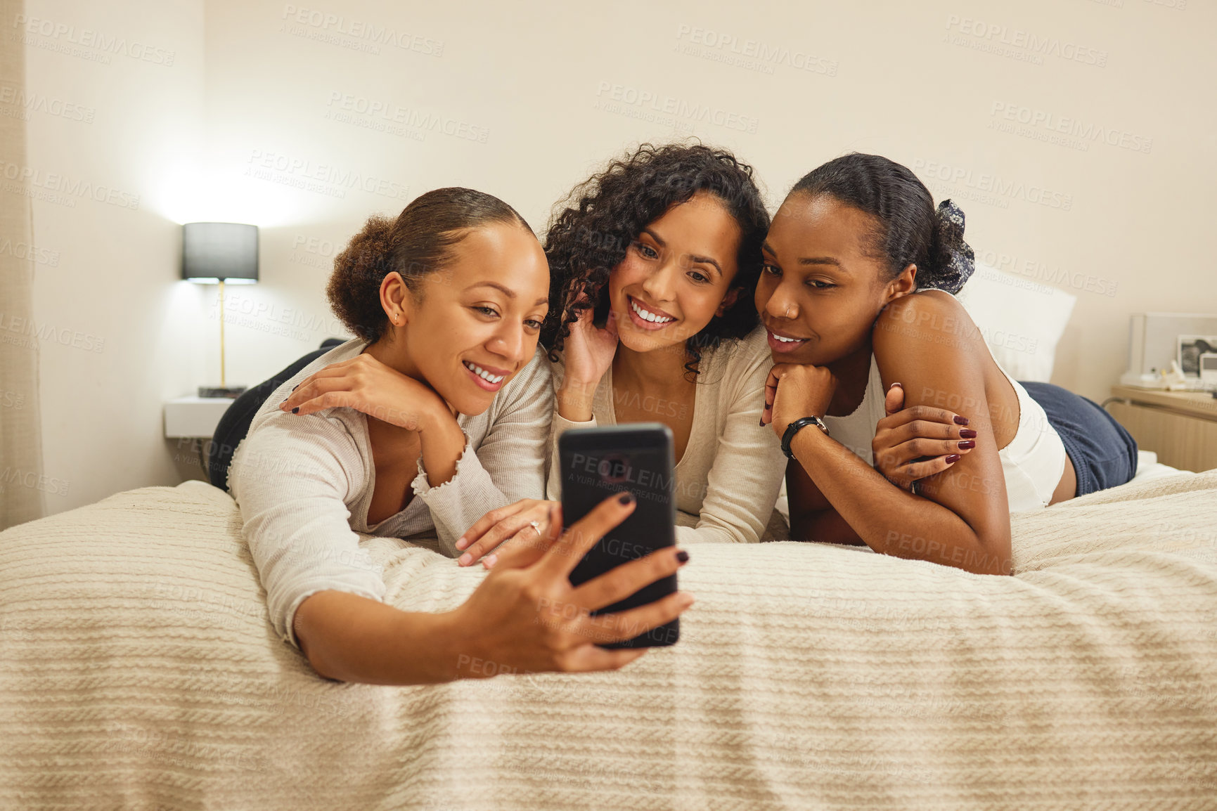 Buy stock photo Women, selfie and friends in a home with profile picture, social media and smile at sleepover. Mobile, bonding and sister love in a bedroom with group, care and memories on a bed with digital app