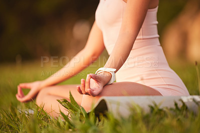 Buy stock photo Cropped shot of an unrecognizable young woman meditating outside on a sunny morning