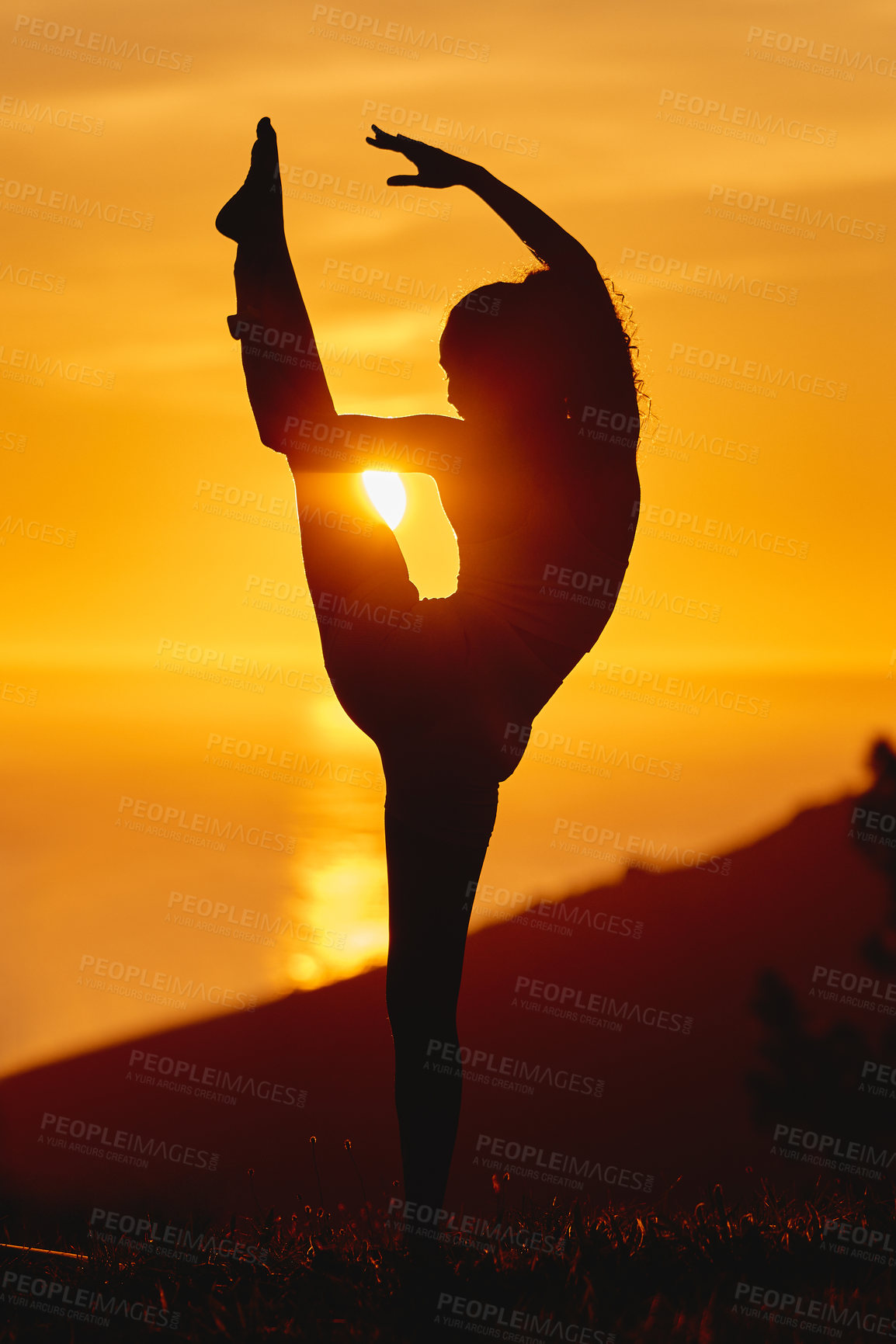 Buy stock photo Yoga, sunset and woman with silhouette with body stretching and flexible pose of leg in air in nature. Outdoor, balance and wellness by the sea with health and dusk with shadow on a hill with zen