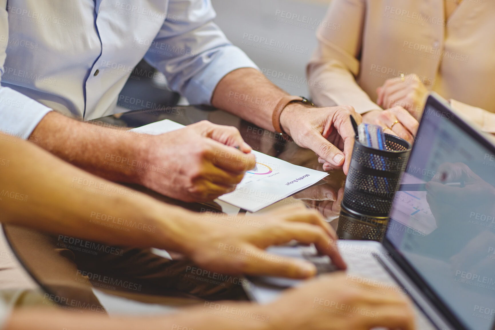 Buy stock photo High angle shot of a group of unrecognizable businesspeople working together on a laptop in the boardroom