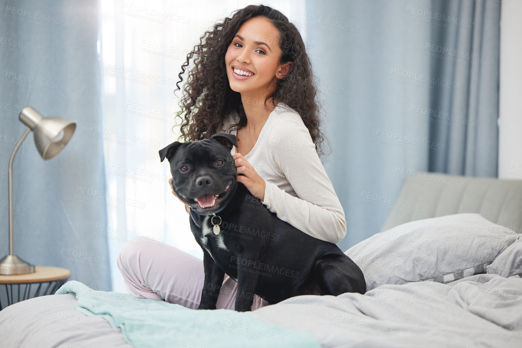 Buy stock photo Shot of a young woman and her dog  in bed at home