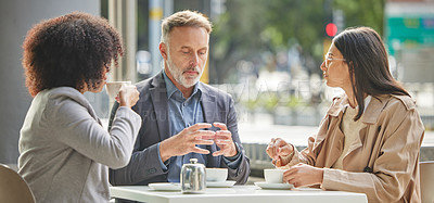 Buy stock photo Shot of a group of colleagues brainstorming ideas at a coffee shop