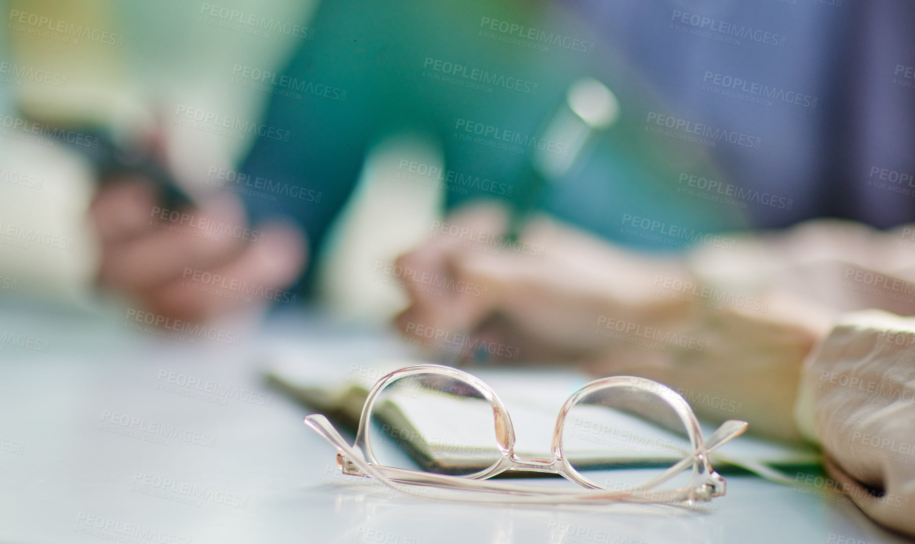 Buy stock photo Glasses on desk, vision and eye care with business people in meeting, writing in notebook with strategy collaboration closeup. Eyewear, prescription lens and notes with ideas, planning with team