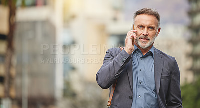 Buy stock photo Shot of a mature businessman using his smartphone to make a phone call