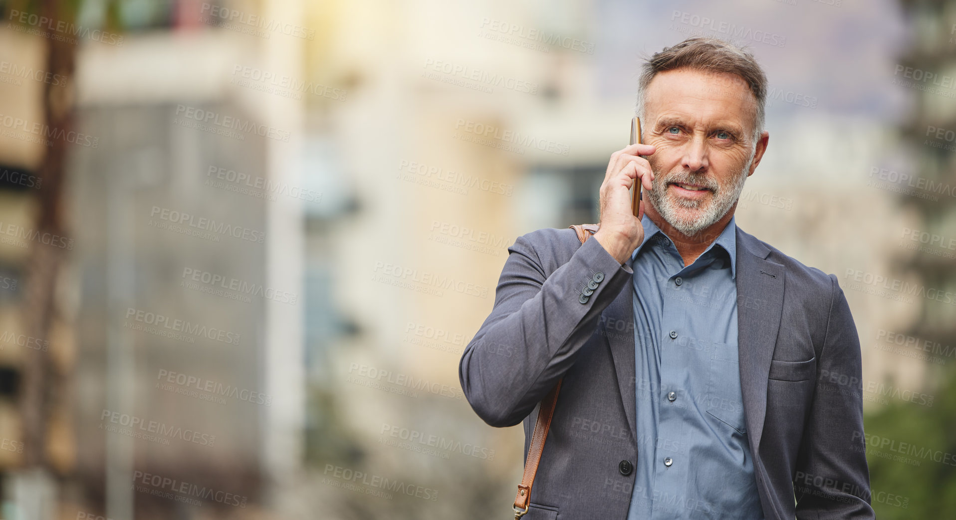 Buy stock photo Shot of a mature businessman using his smartphone to make a phone call