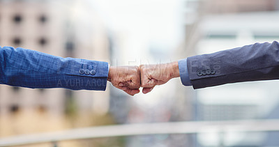Buy stock photo Cropped shot of two unrecognizable businessmen fist bumping outside