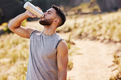 Buy stock photo Man, drinking or water in nature or runner with bottle, workout or exercise for health. Male athlete and liquid or container for sports in countryside, trail marathon or running for wellness in Iraq